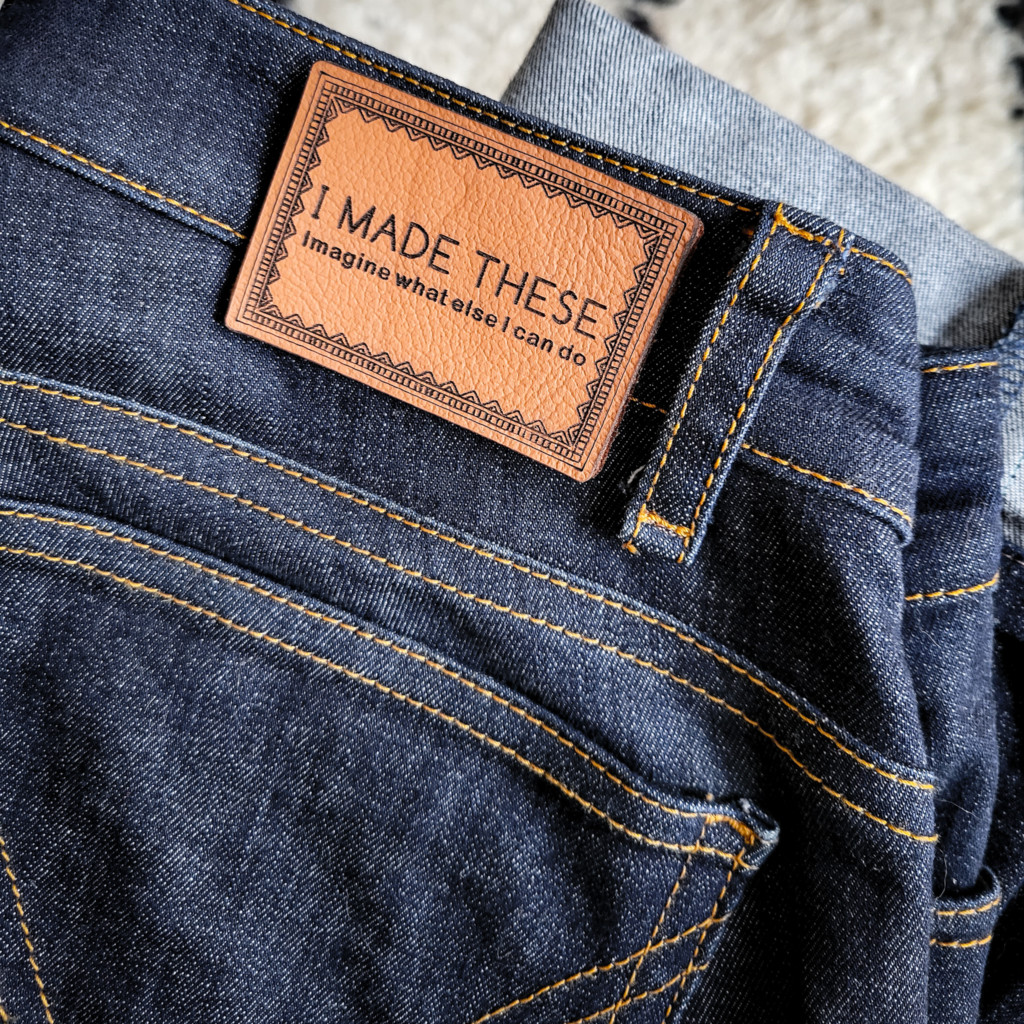 Handmade jeans with a leather label stating, "I made these, imagine what else I could do."