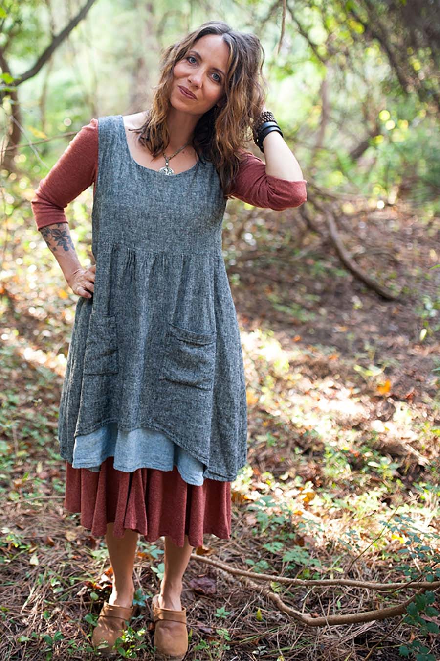 Meg wears a metamoprhic dress in the woods