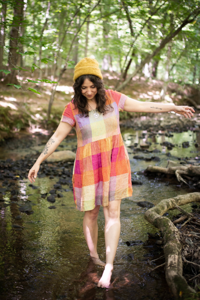 Meg wearing a rainbow hinterland in a creek.