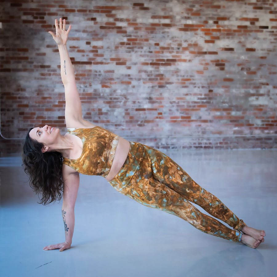 Meg does a side plank in her ice dyed copper Limestone leggings and top set