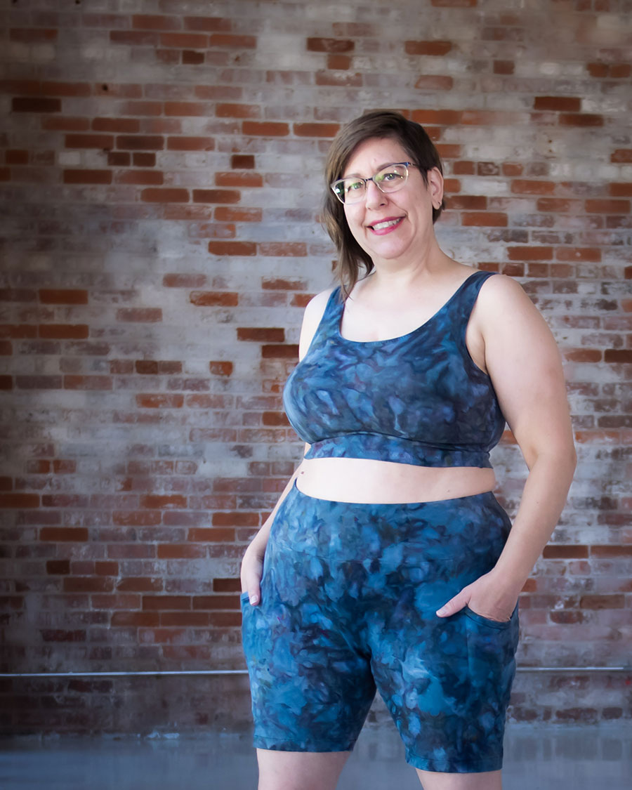 Shaerie wears blue ice dyed Limestone bike shorts and top