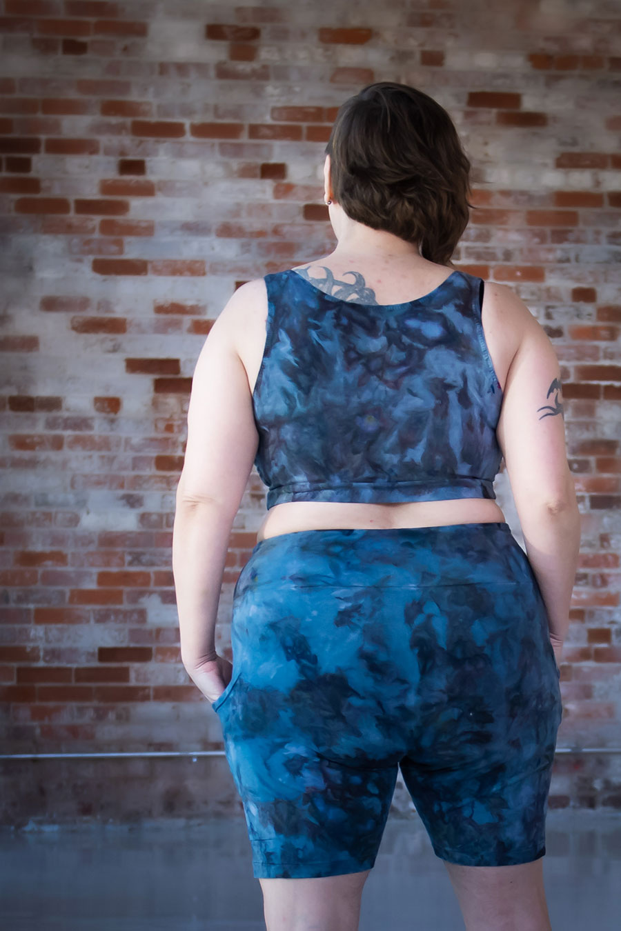 Back view of Shaerie's blue Limestone bike shorts and top set