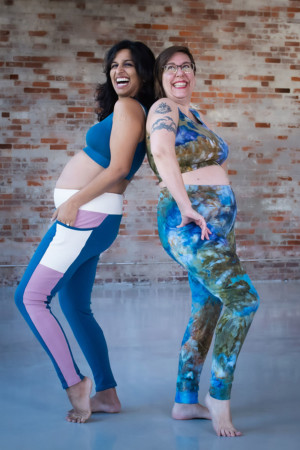 Sophia and Shaerie stand back to back wearing their Limestone leggings and top sets
