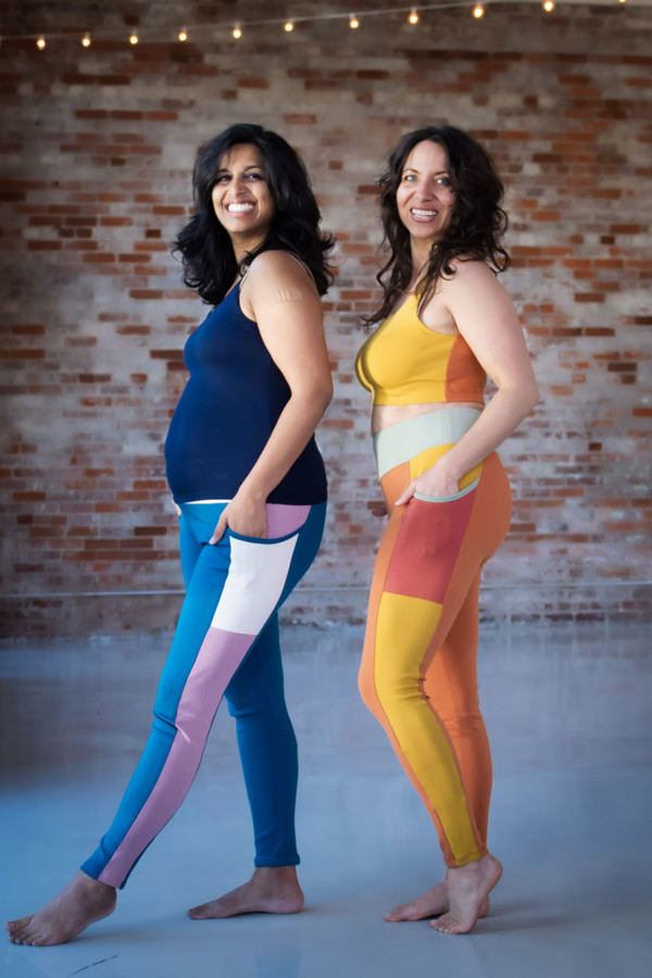 Meg and Sophia wearing their colorblocked Limestone leggings and top sets