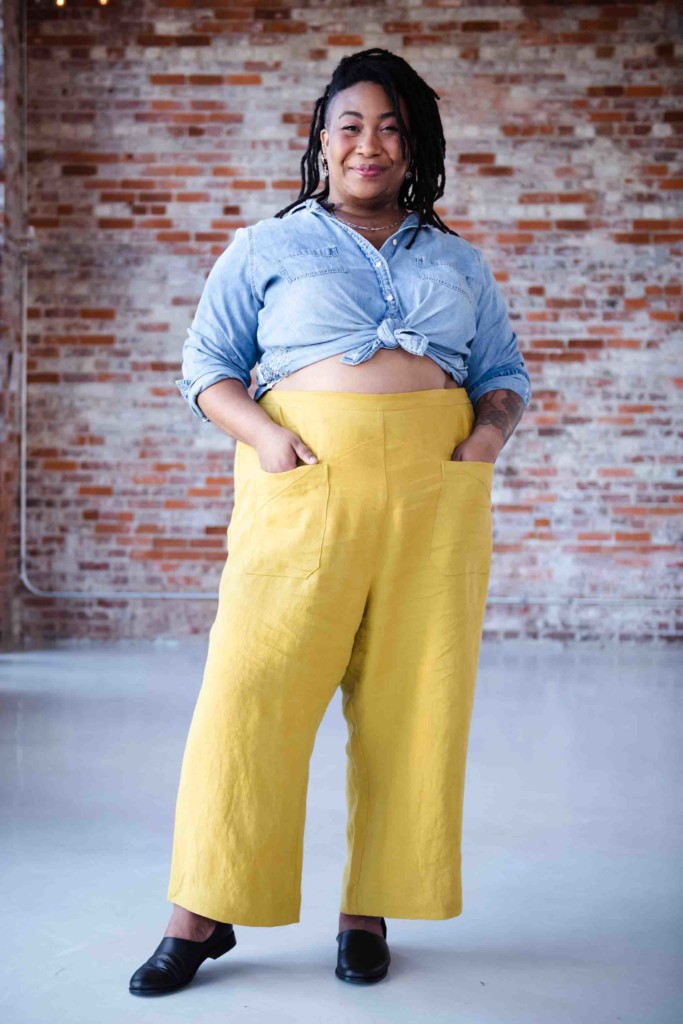 Ashley wears yellow cosecha pants and a chambray shirt. 