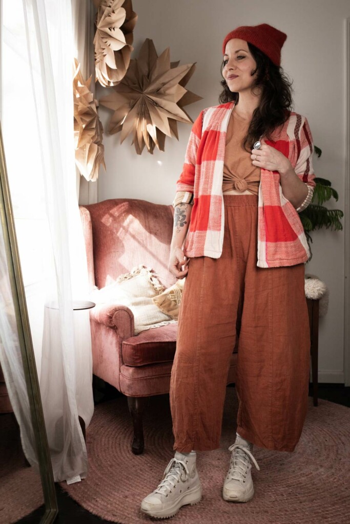 Meg wears rust Arthur Pants and a pink Bedrock Tee tied in the front.