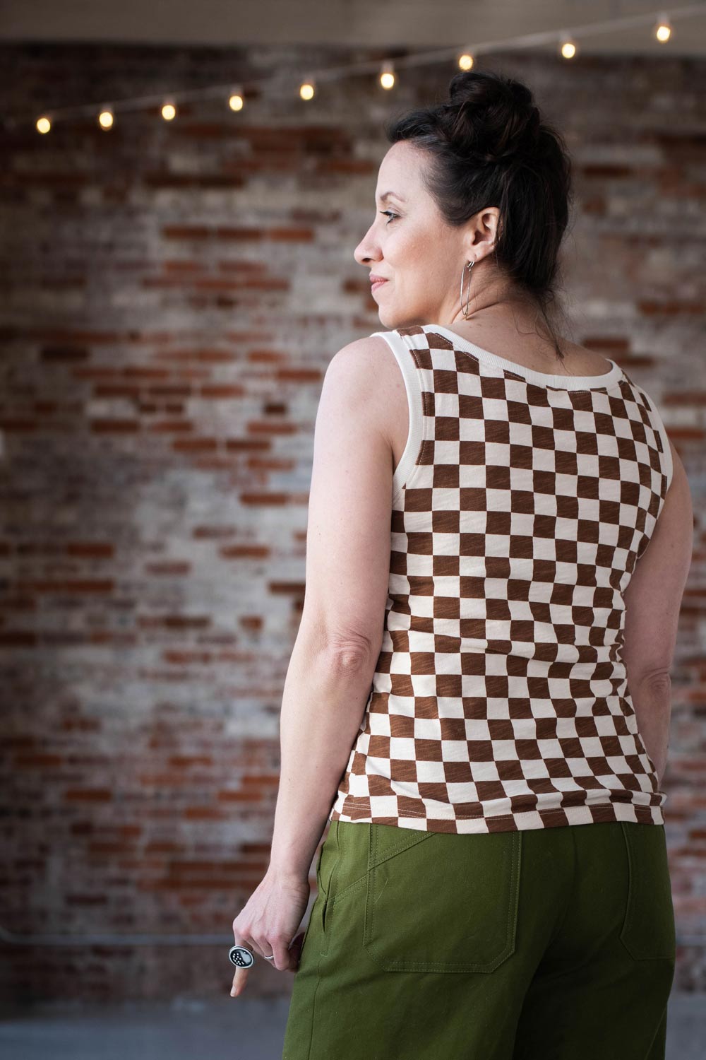Meg showing the back of her checkered Bedrock Tee