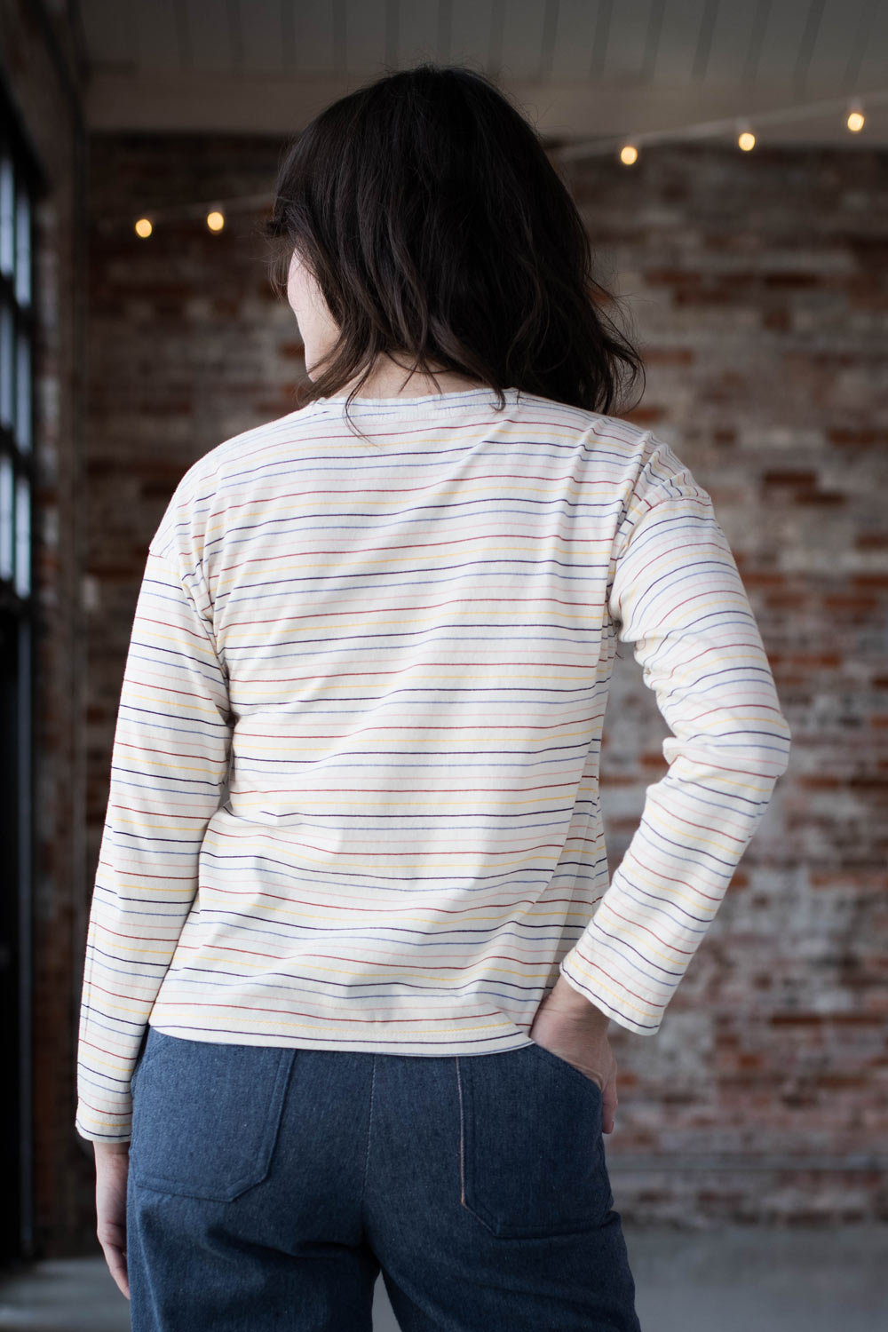 Meredith shows the back of her striped Bedrock Tee.