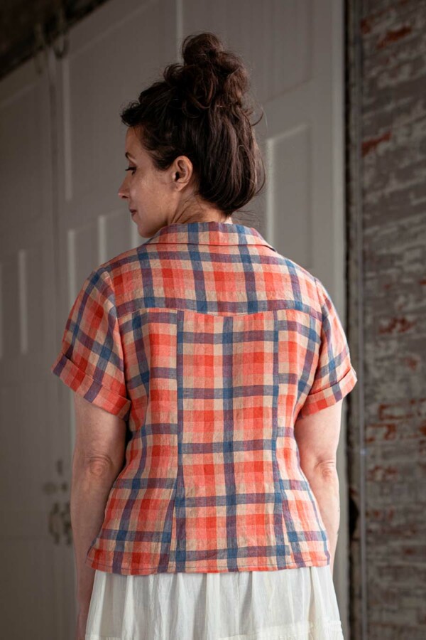 Meg wearing a red plaid, view a Joanie Top