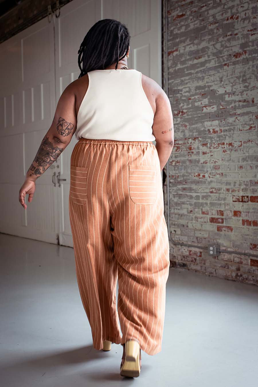 Ashley wearing striped view a chanterelle pants and a cream tank