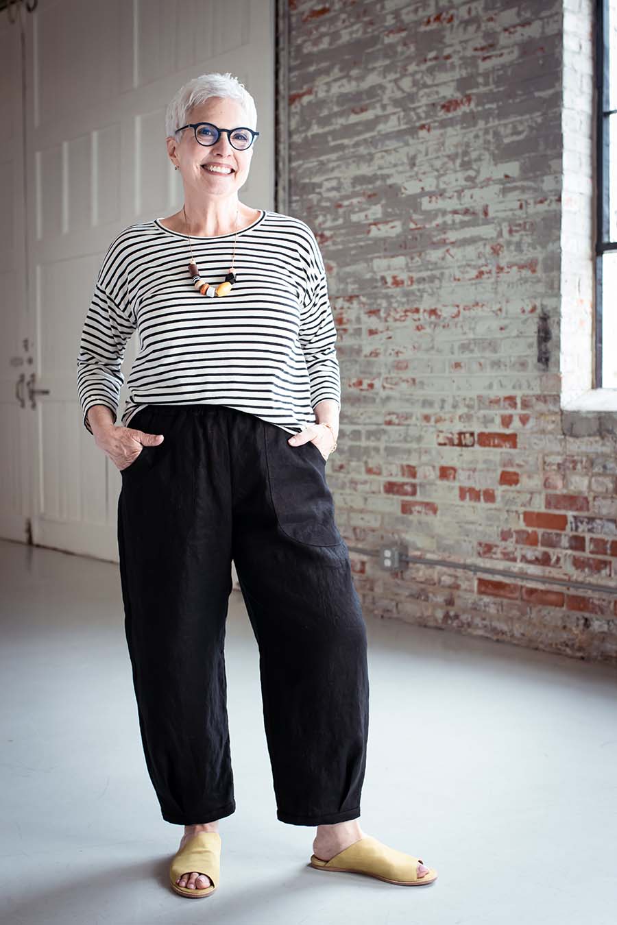 Cindy wears black chanterelle pants and a striped top