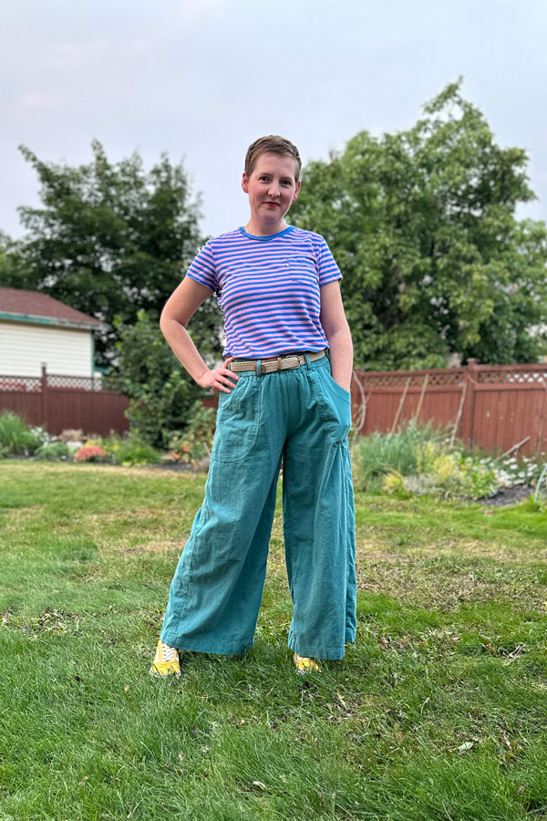Judith wears a striped tee shirt and green corduroy chanterelle pants with belt loops