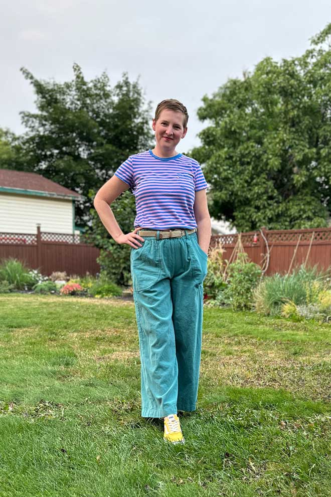 Judith wears a striped tee shirt and green corduroy chanterelle pants with belt loops
